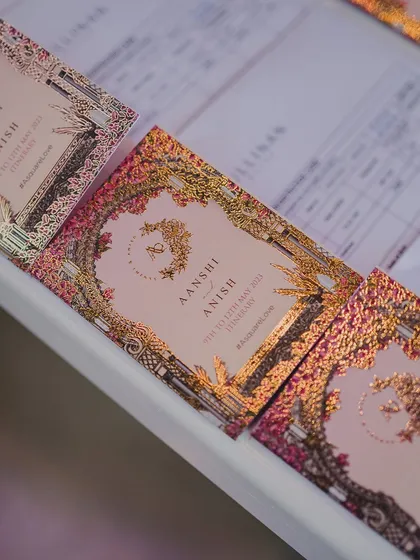 Exquisite wedding invitations with intricate gold foil and a floral design. The invitation is the first glimpse guests have of the wedding, and we make sure it's a grand one.