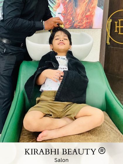 Yes, kids love our salon too. This little guy is relaxing and enjoying his hair wash before getting a smart new haircut.
