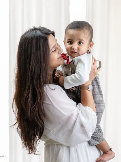 A candid moment between a mother and her smartly dressed son. I love capturing these authentic interactions that show a family's personality.