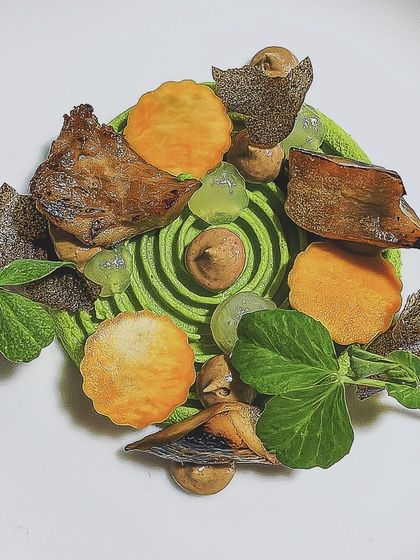 A Green Pea Tourbillon. This vegetarian starter features a spiral of pea purée with mushroom textures, pumpkin, and a Riesling gel for a touch of acidity.