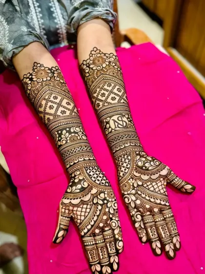 Another example of a personalized bridal design with initials, set against a backdrop of intricate patterns.