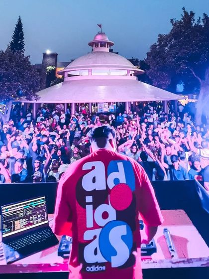 A view from behind the console at Wonderla for International Men's Day. The open-air setting with a massive, energetic crowd is an incredible sight.