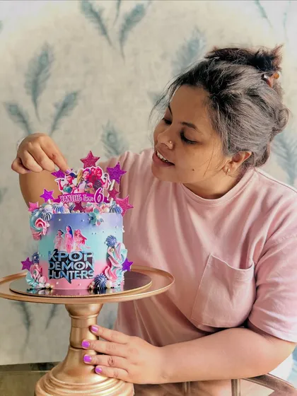 Hi, I’m Sarita! This is me adding the final touches to a custom cake. Every dessert from my kitchen is a piece of my heart, baked with the same passion and care I use for my own family.