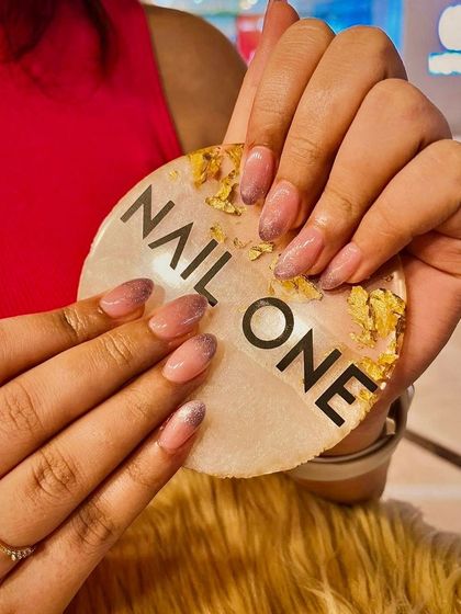 A dreamy and sophisticated look featuring a soft ombré blend with a subtle glitter finish. This manicure is perfect for those who want a touch of sparkle without being too bold.