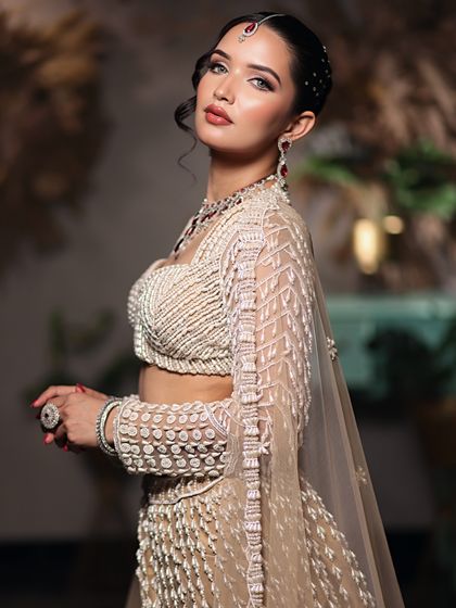 A side profile showcasing the elegant updo and the way the soft glam makeup enhances the model's features.