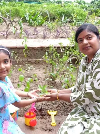 A mother and daughter plant a sapling in a garden, symbolizing their shared commitment to a greener future.