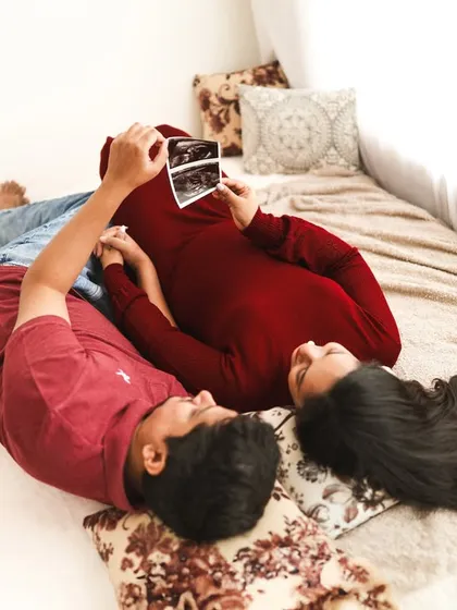 "LOVE groes here." This creative shot of the couple looking at their ultrasound photo is a perfect way to document the very beginning of their baby's story.