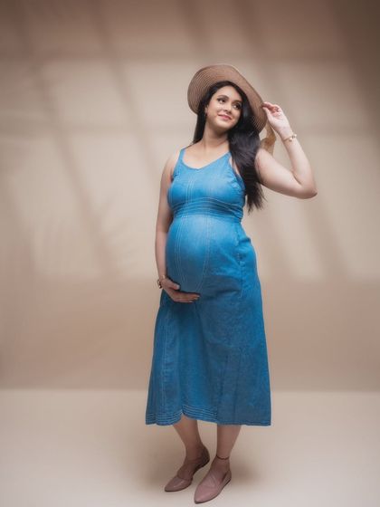 Glowing with love and elegance. This stunning mumma-to-be's radiance shines through in every click, captured in a simple yet beautiful denim dress.