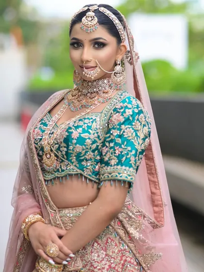 For this look, I paired a teal and pink lehenga with smoky eyes and a nude lip. It's a modern and sophisticated take on bridal makeup.