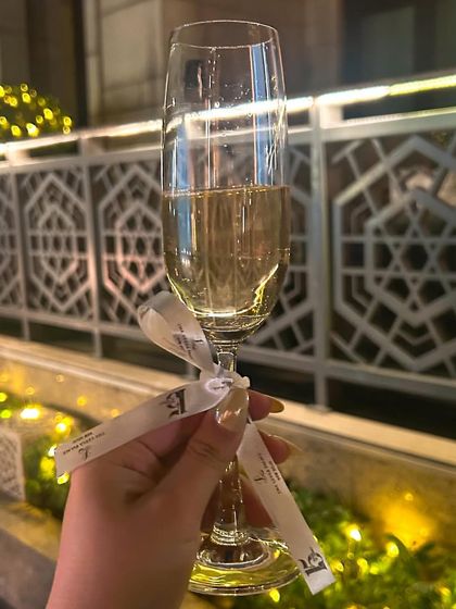A celebratory glass of champagne at The Leela Palace's 15th anniversary. Attending and posting from events like this helps amplify the brand's message and celebration.