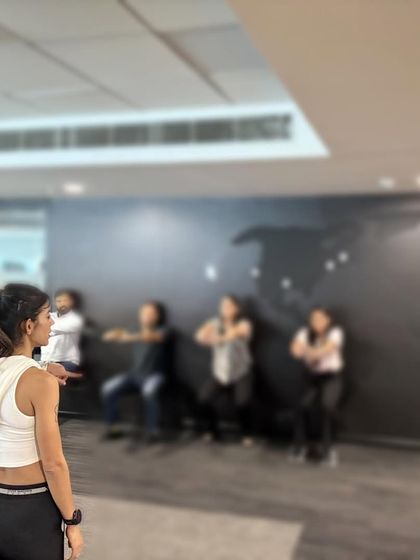 Guiding a corporate team through exercises. My sessions are designed to be effective and require no fancy equipment, making it easy for anyone to participate and feel the benefits.