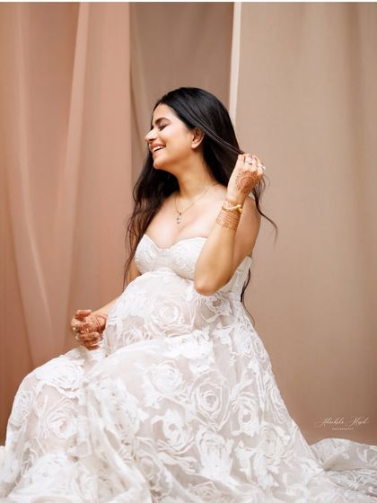 A candid moment of laughter and joy in a beautiful white lace gown, showing the relaxed and happy atmosphere of my studio.