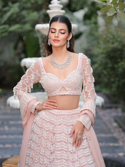 A moment of serene beauty. The soft shimmer on her eyes and the gentle contouring enhance her features without overpowering them.