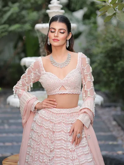 A moment of serene beauty. The soft shimmer on her eyes and the gentle contouring enhance her features without overpowering them.