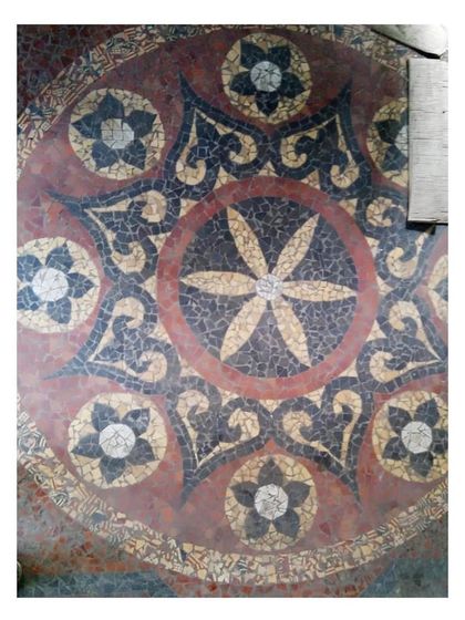 A close-up of a circular floral mosaic pattern. The careful restoration of these floors is a testament to the incredible Indian craftsmanship we sought to preserve.
