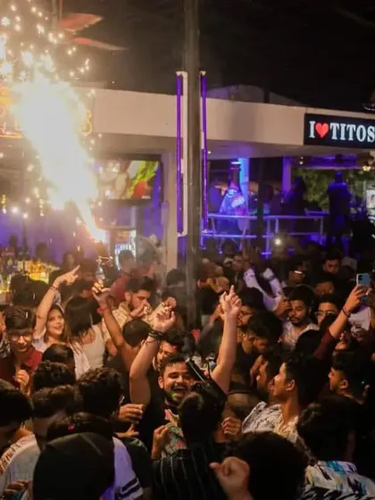 A packed dance floor at Tito's is illuminated by a burst of pyrotechnics. These moments create a huge energy spike during my sets.