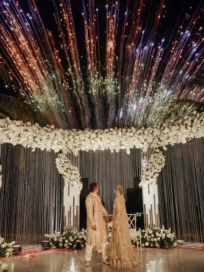 A sky full of fireworks for a love that's just as explosive. This shot captures the magic of a Varmala under the stars in Goa.