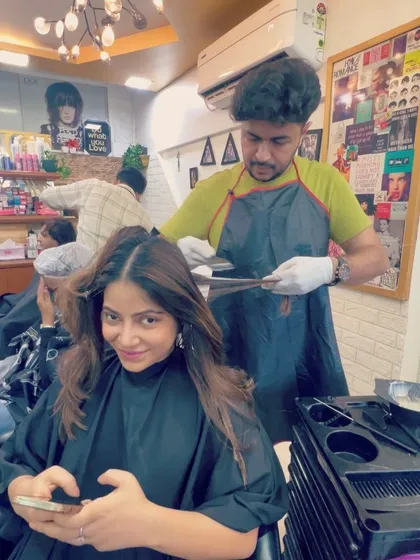 A client getting her caramel balayage. The process involves careful sectioning and application to create that seamless, natural-looking blend.
