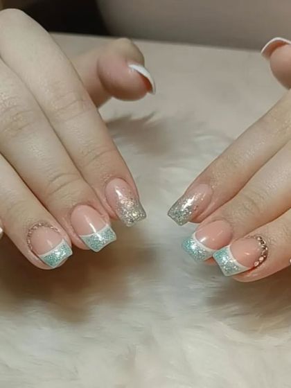 Another view of the mint green glitter French tip design, showing the full set.