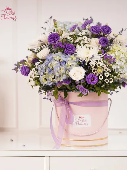 This is one of my signature luxury flower boxes, featuring a lush mix of purple eustoma, soft blue hydrangeas, and crisp white chrysanthemums. The arrangement is presented in a chic pink bucket box, making it a ready-to-display centerpiece for any occasion.