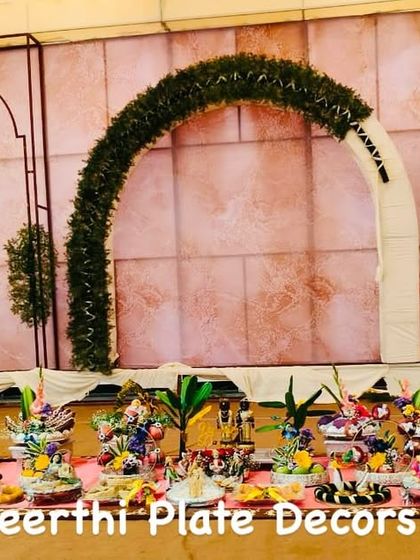 This engagement setup at MS Mahal features a modern arch backdrop. My platter arrangements on the floor add a touch of traditional elegance to the contemporary decor.