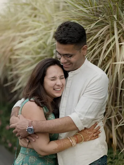 There is nothing better than a real, full-hearted laugh. This candid photo captures a couple sharing a joyful hug during their outdoor portrait session. My approach is to guide you gently, but the best shots always happen when you forget I'm even there.