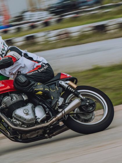 A close-up action shot from the RE GT Cup Zonal Selection in Bangalore, showing a rider's intense focus while cornering.