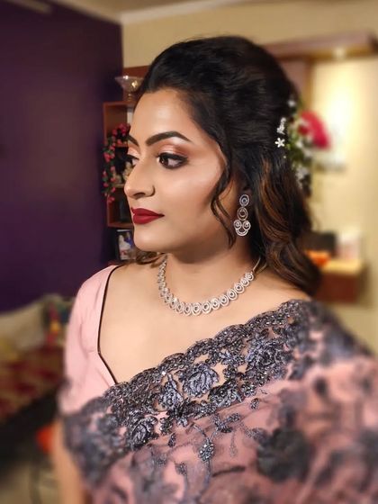 A side profile showing the beautiful half-up hairstyle with fresh flowers.