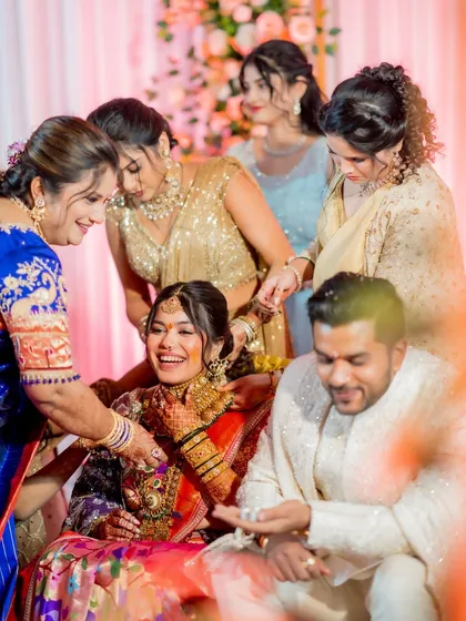 A fun, candid moment during the ring ceremony. The bride's makeup remains flawless, capturing her laughter and joy perfectly.