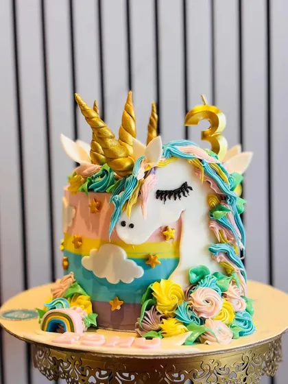 I love bringing fantasy to life with cakes like this magical unicorn design. Featuring a rainbow of pastel buttercream, a sculpted unicorn, and golden horns, it’s a whimsical centerpiece perfect for a child's fairytale birthday party.