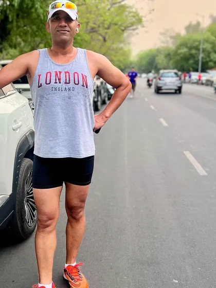 A member looking fit and proud during the anniversary run. We celebrate fitness and relationships.