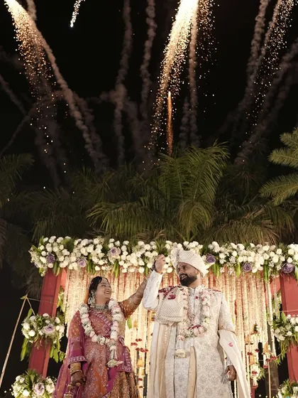 Love that lights up the sky. This stunning shot captures the couple during their varmala ceremony, perfectly framed by a spectacular fireworks display that I coordinated for their grand finale.