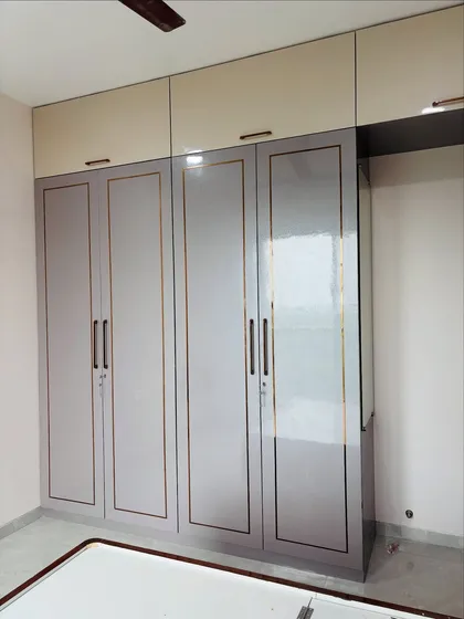 A frontal view of the grey wardrobe, highlighting the clean lines and minimalist hardware.