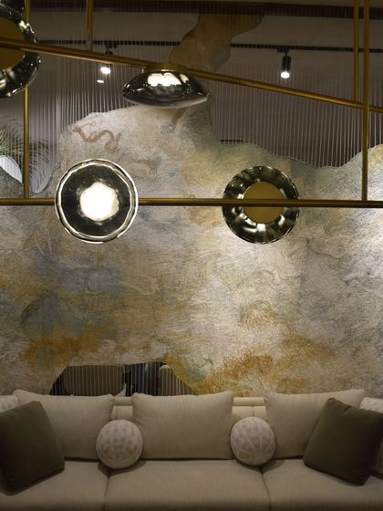 A close-up of the Ceto chandelier, with its rippled glass discs beautifully reflecting the light and the surrounding environment.