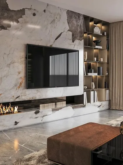 For a truly dramatic living room, I designed this stunning TV wall with a marble finish and an integrated fireplace. The backlit bookshelf adds warmth and a place for personal display, creating a cozy yet luxurious atmosphere.