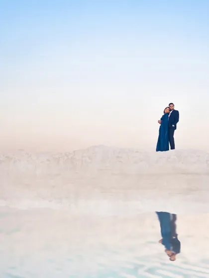 A breathtaking shot from a pre-wedding session at the salt plains of Jaipur. The reflection creates a surreal, minimalist composition that emphasizes the couple's bond.