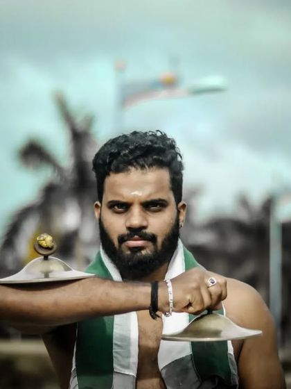 The Ilathalam player, holding the cymbals that are essential to the rhythm of the Chenda Melam.