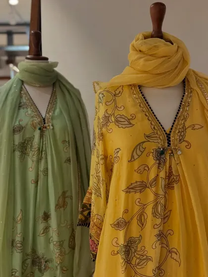 A closer look at the pastel green and yellow printed kurtas, highlighting the delicate block-print style floral motifs.