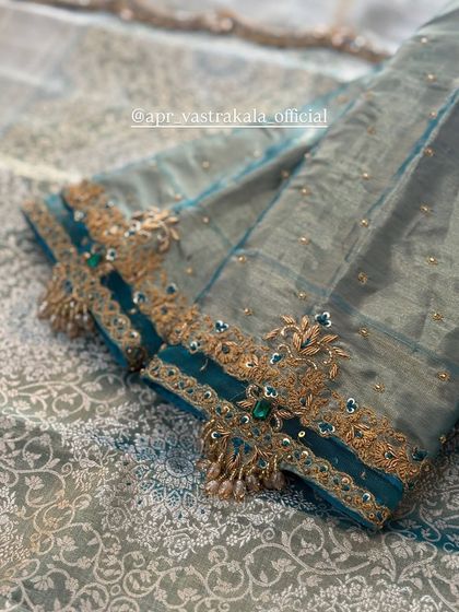 A sleeve with a sheer panel and intricate cuff embroidery.