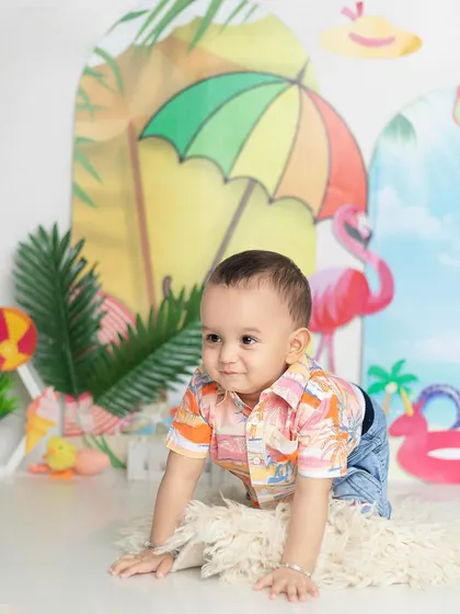 Let's go to the beach! This summer-themed shoot is full of bright colors and fun props like flamingos and beach balls.