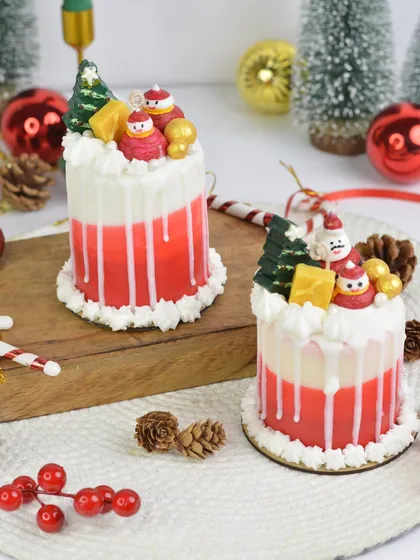 My Christmas cake candles are a festive treat for the eyes. With their red and white layers and tiny Santa toppers, they look delicious.