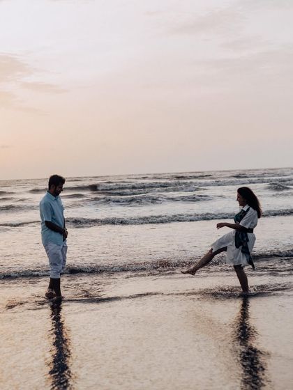 Capturing the fun side of their relationship with a playful kick in the water. It's these real, candid interactions that make a pre-wedding shoot special.