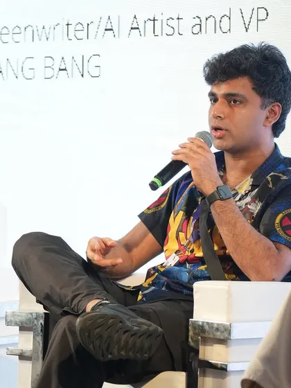A close-up of me speaking at Film Bazaar. I'm wearing a shirt with my own 'Parmanupunk' designs on it.