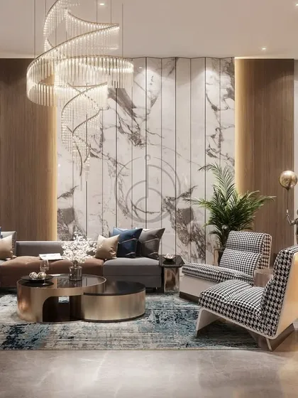 A full view of the lounge area, where an L-shaped sofa and patterned armchairs are arranged around a modern fireplace. The spiral chandelier draws the eye upwards, emphasizing the room's height and grandeur.