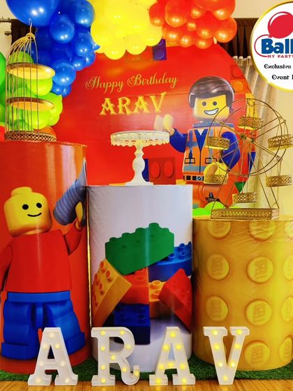 A close-up of LEGO-themed dessert plinths, decorated to look like giant LEGO bricks and featuring a mini ferris wheel.