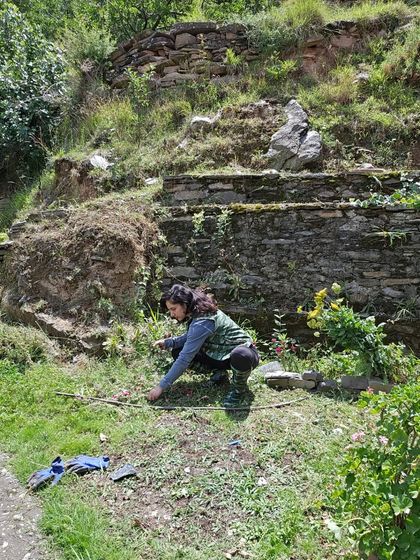 Tending to the plants in my camouflage boots. Life on a farm means being ready for anything, and I love every bit of it.