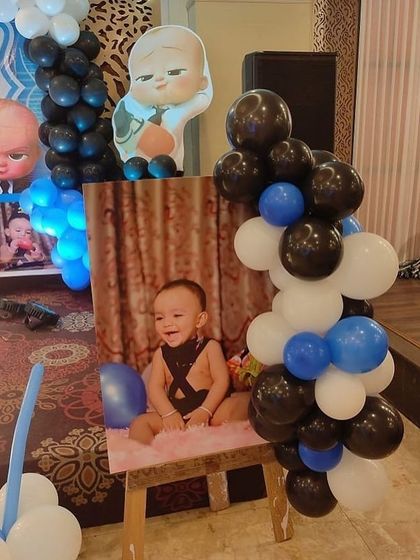 A personalized photo display at a Boss Baby party, featuring a picture of the birthday boy.