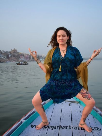 Rooted in the flow, rising with the soul. A powerful yoga pose on the Ganga, capturing the fusion of physical strength and spiritual awakening in Varanasi.