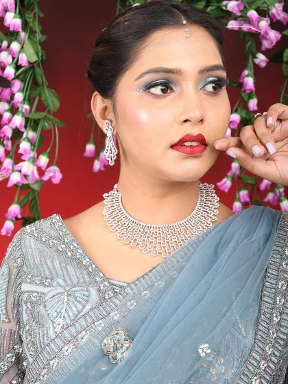 A glamorous reception or party look. I created a silver and blue smokey eye with a bold red lip, paired with a stunning diamond necklace for a look that is pure elegance.