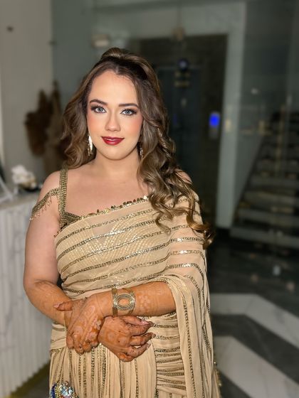 Glowing in gold for an evening event. This look features a classic red lip and a subtle winged liner, paired with a radiant base for a timeless, glamorous feel.